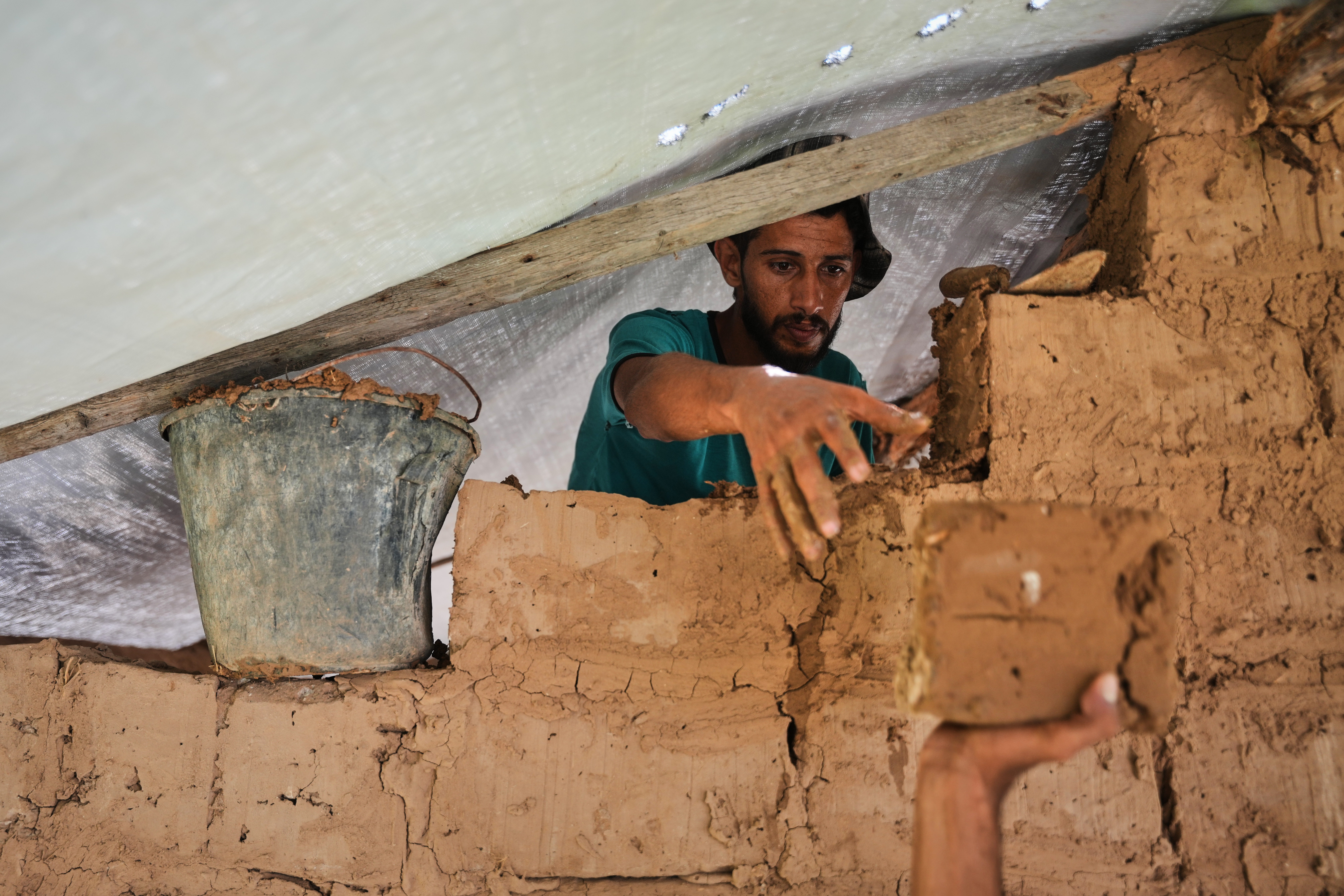 Palestinians rebuild Gaza’s ruins with mud bricks and scrap
