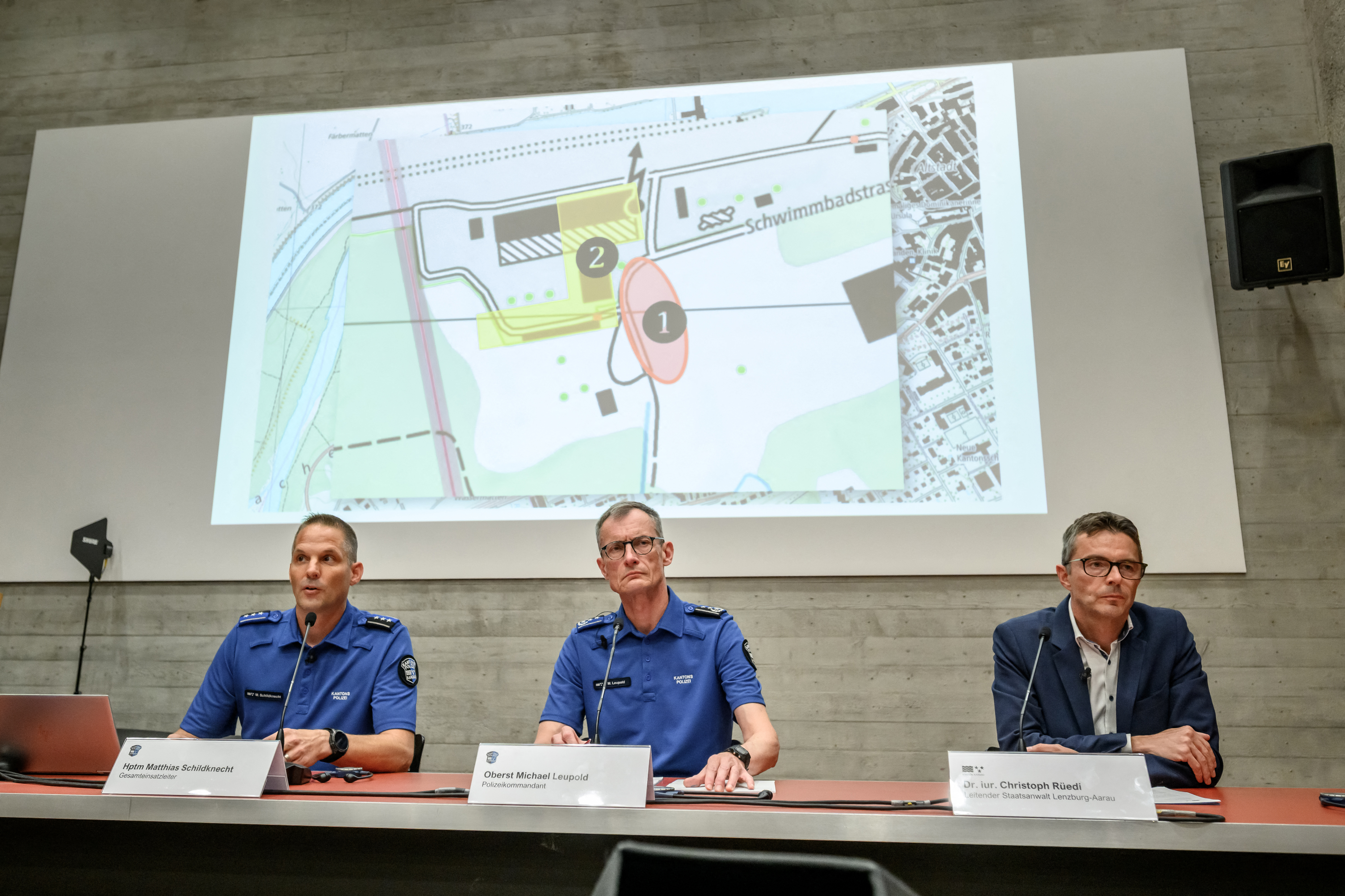 (From L) Head of Operations in Aargau Canton Police Matthias Schildknecht, Aargau Canton Police Commander Michael Leupold and Lenzburg-Aarau District Attorney's Office head Christoph Ruedi attend a press conference following a shooting at a rave party in Aarau, in Schafisheim, northern Switzerland on September 2, 2026.