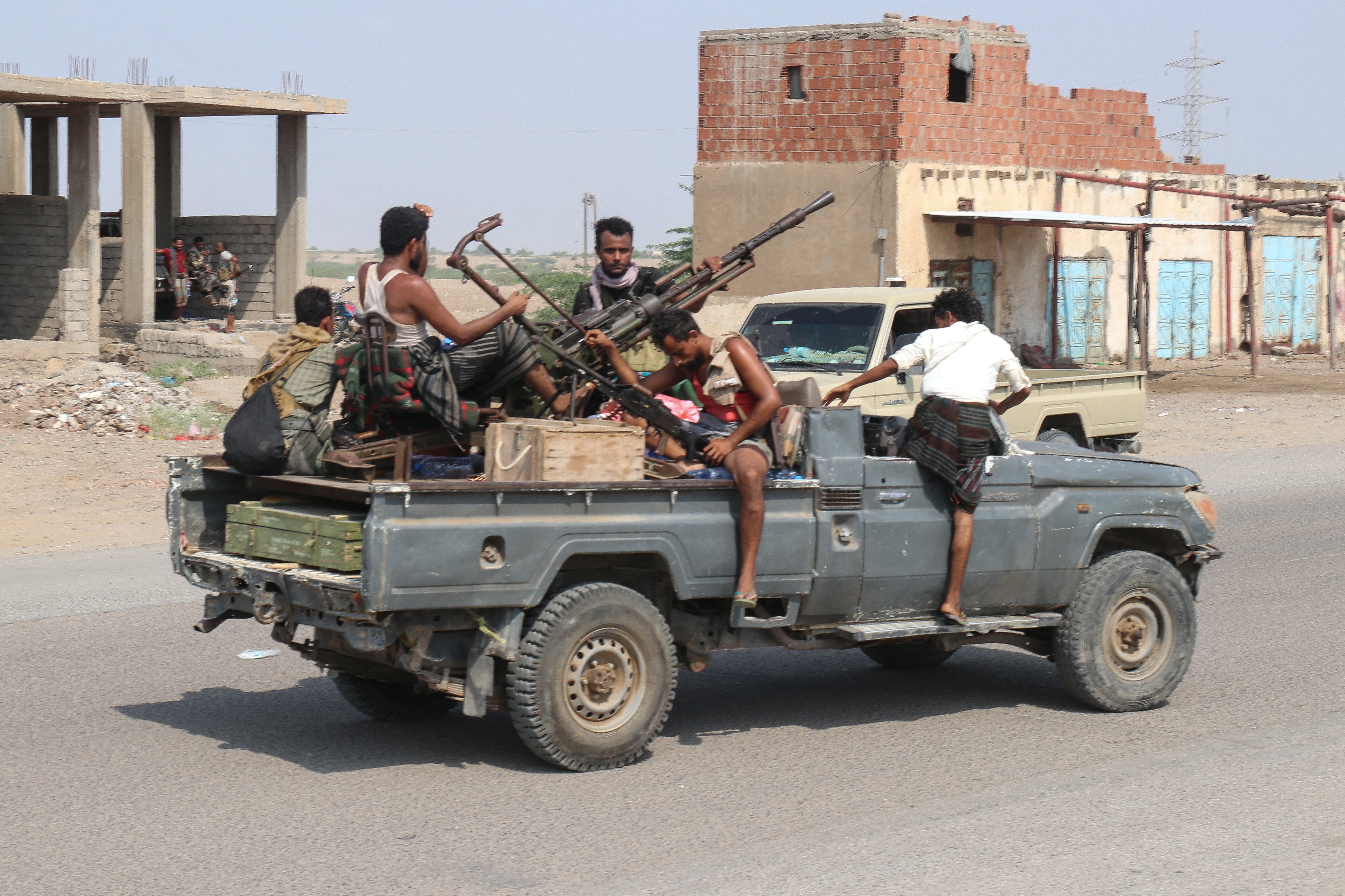Forces loyal Yemen's Saudi-backed government ride in a pick-up truck in the Hays district, south of Hodeidah on September 5, 2026.