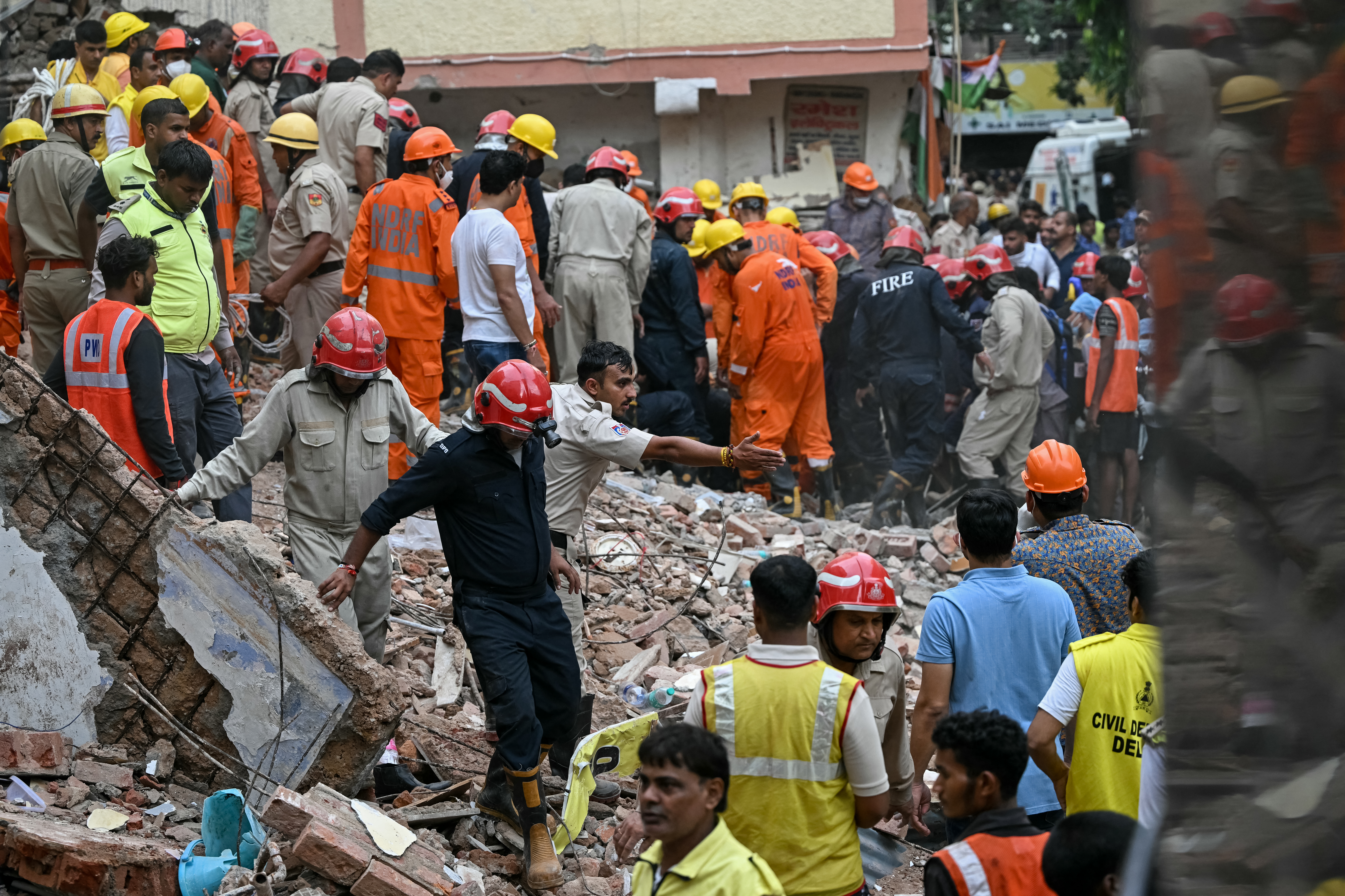 Rescue personnel conduct a search operation for survivors at the site of a building collapse in the Satya Niketan area in New Delhi on September 6, 2026.