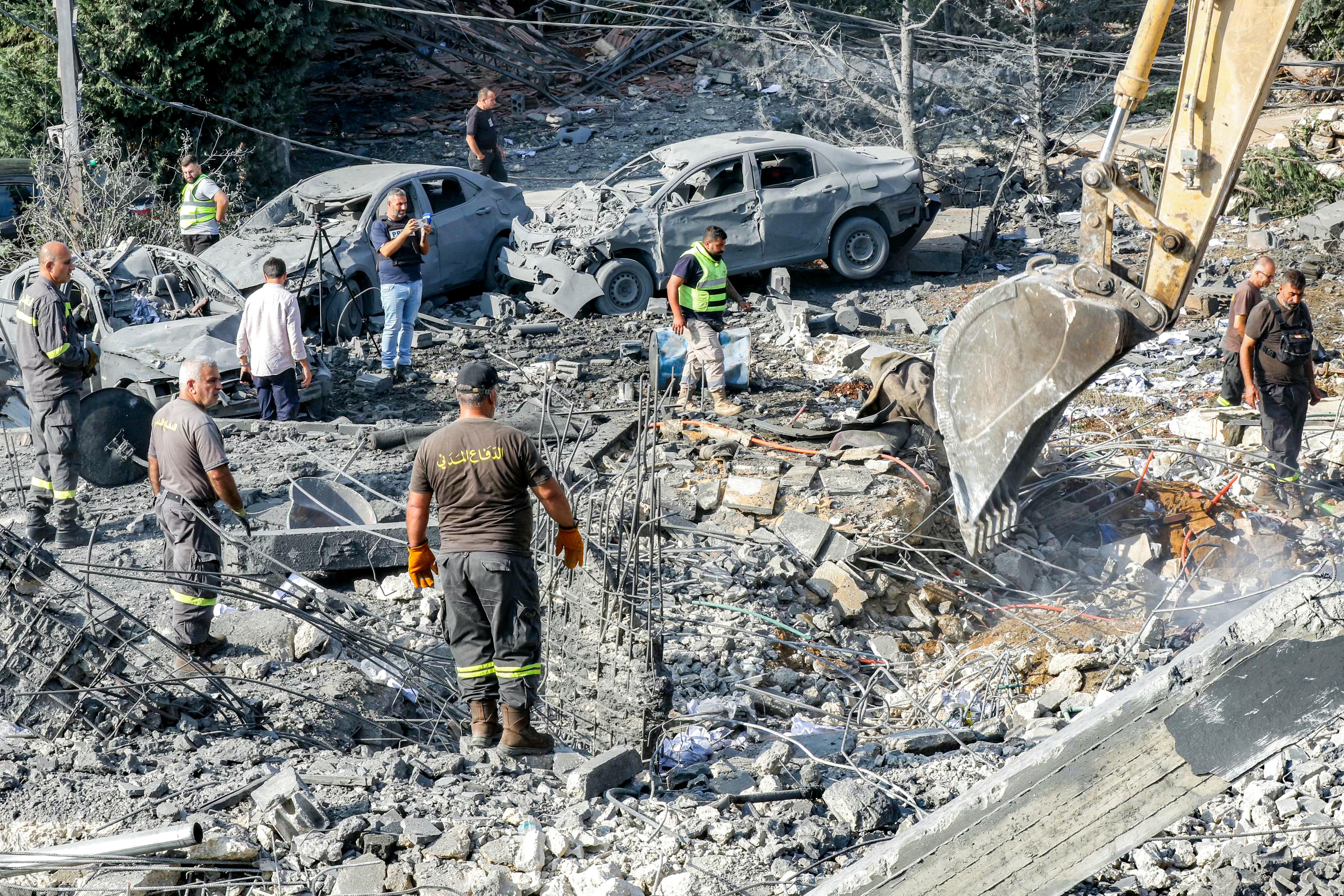 An excavator digs as rescuers search for survivors amidst the rubble following an overnight Israeli airstrike on the village of Kfar Roummane in southern Lebanon on September 7, 2026.