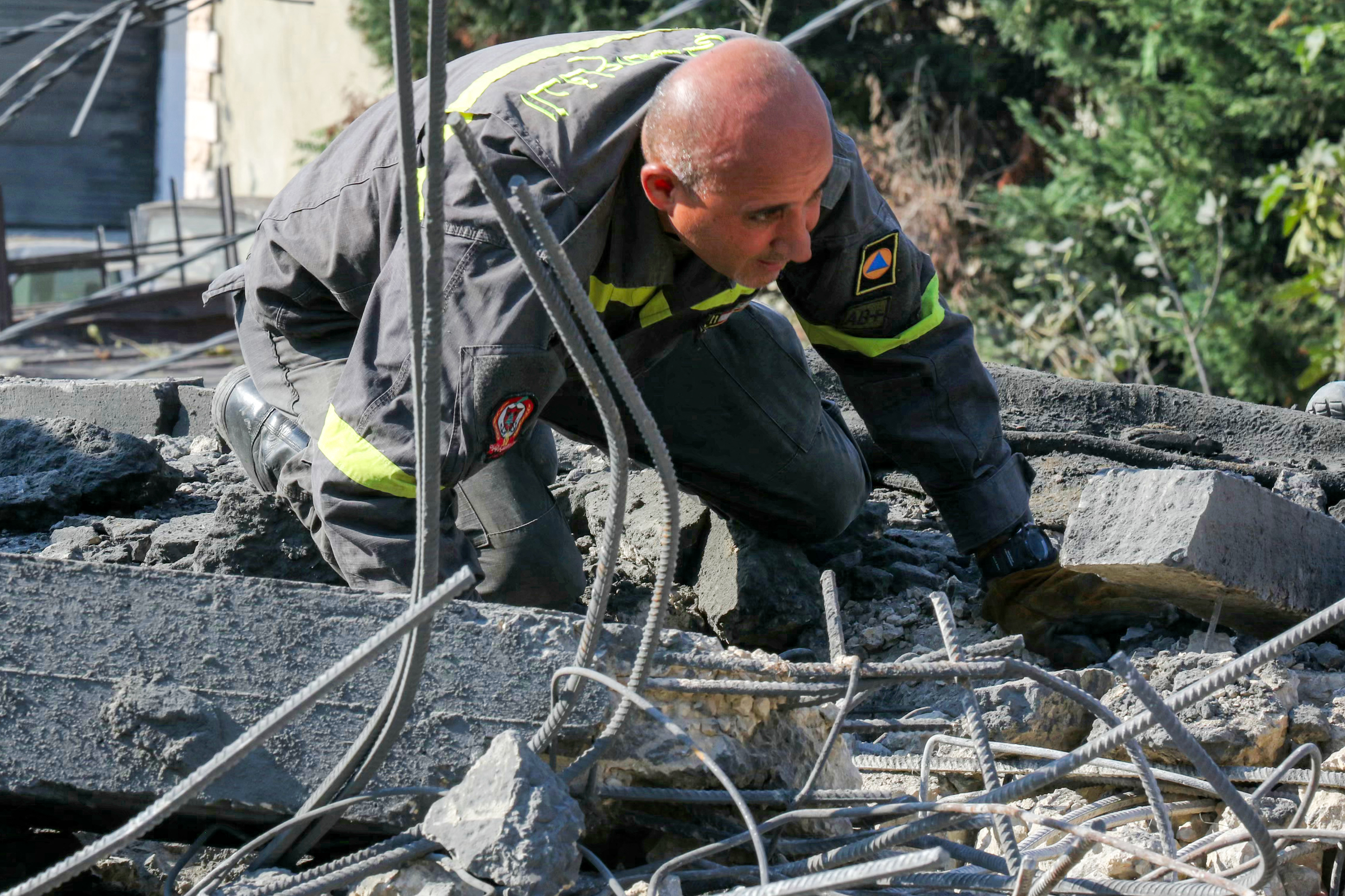 A rescuer searches for survivors amidst the rubble following an overnight Israeli airstrike on the village of Kfar Roummane in southern Lebanon on September 7, 2026.
