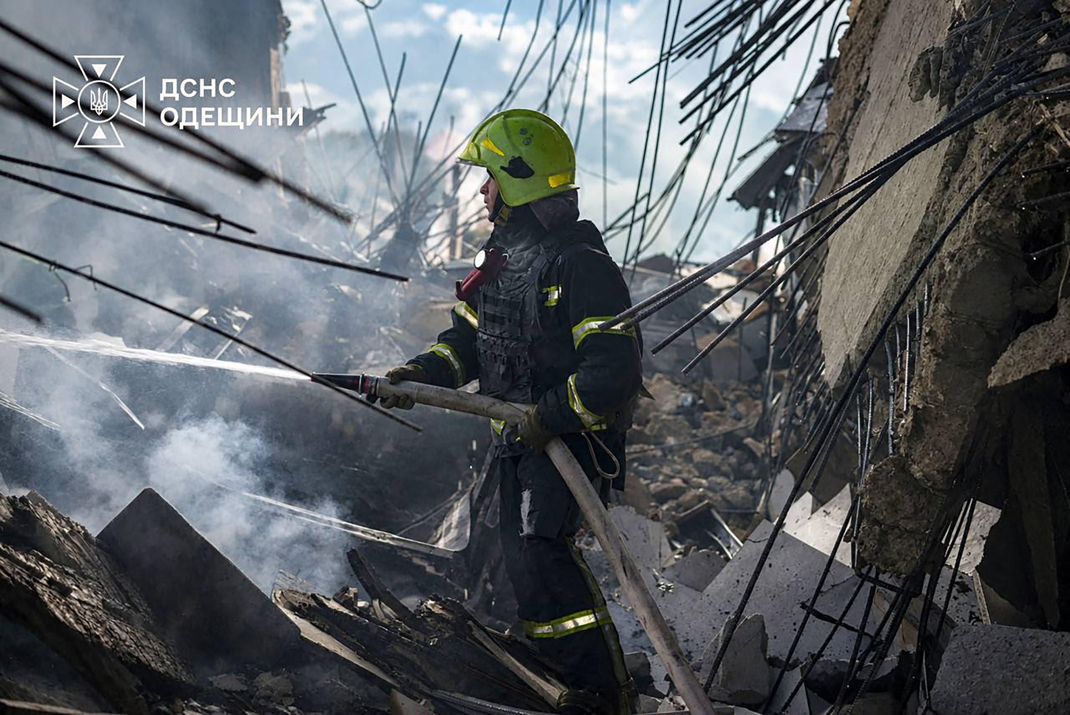 A firefighter works to put out fire in a multistorey building in the Ukrainian city of Odesa