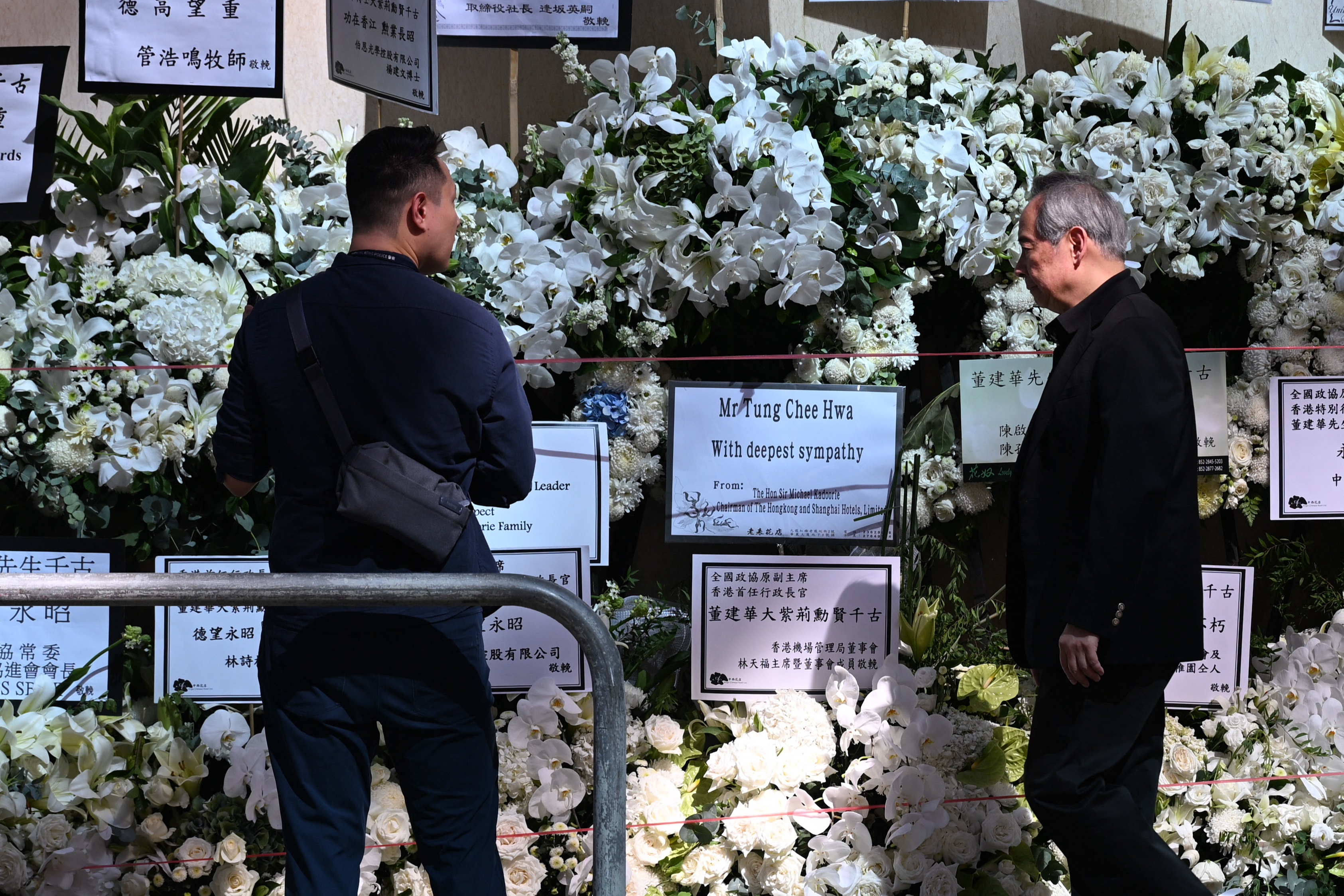 Mourners arrive at the Hong Kong Funeral Home in North Point to pay respects to Tung Chee-hwa
