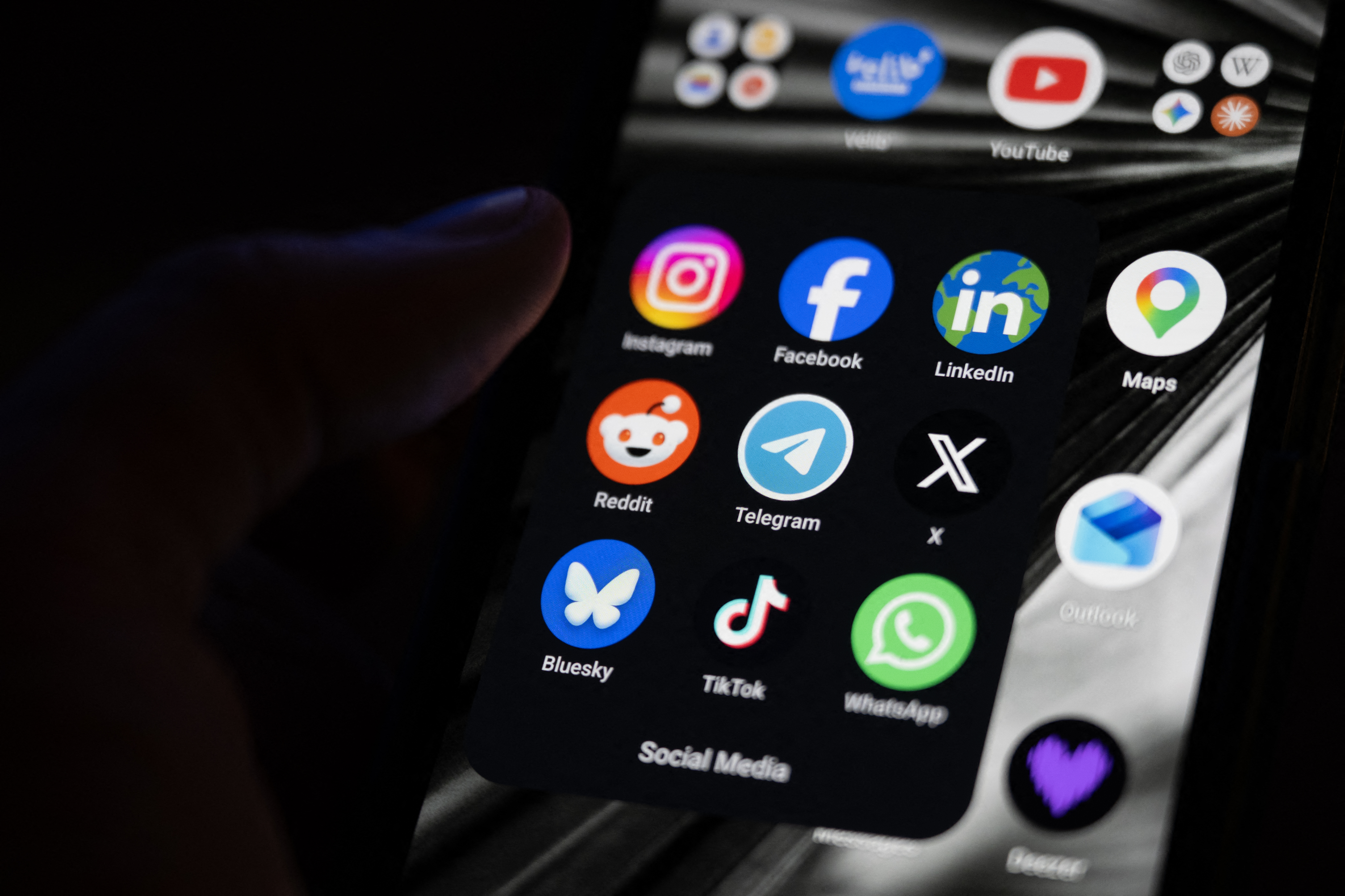 (FILES) This photograph shows a set up smart-phone screen displaying the logo of main social media platforms including Instagram, Facebook, LinkedIn, Reddit, Telegram, X, Bluesky, Tiktok and Whatsapp in Saint-Mande, east of Paris, on April 29, 2026.