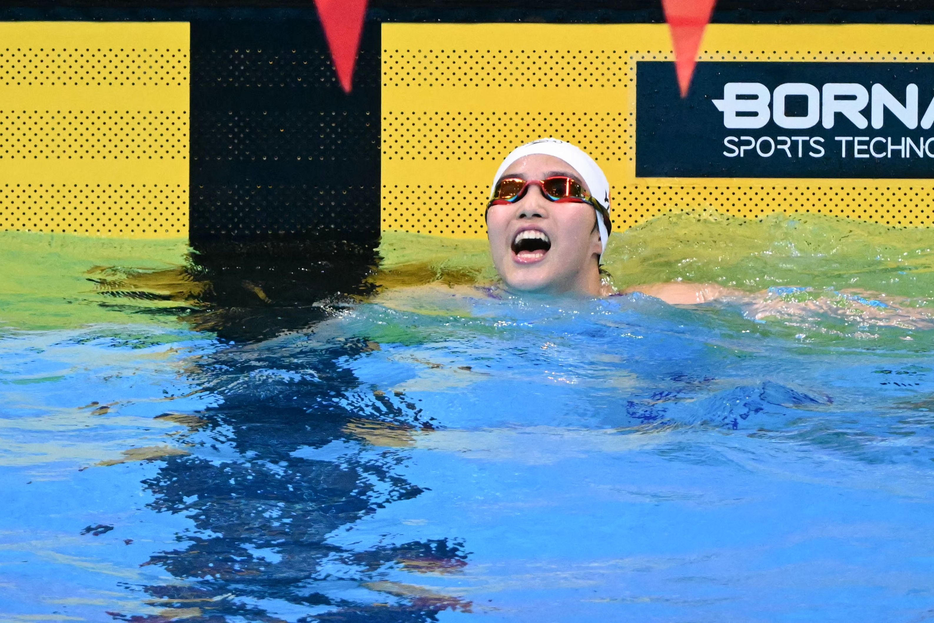 China's Yu Zidi celebrates after winning the final of the women's 200m individual medley swimming event during the 2026 Asian Games at the Tokyo Aquatics Centre in Tokyo on September 21, 2026.