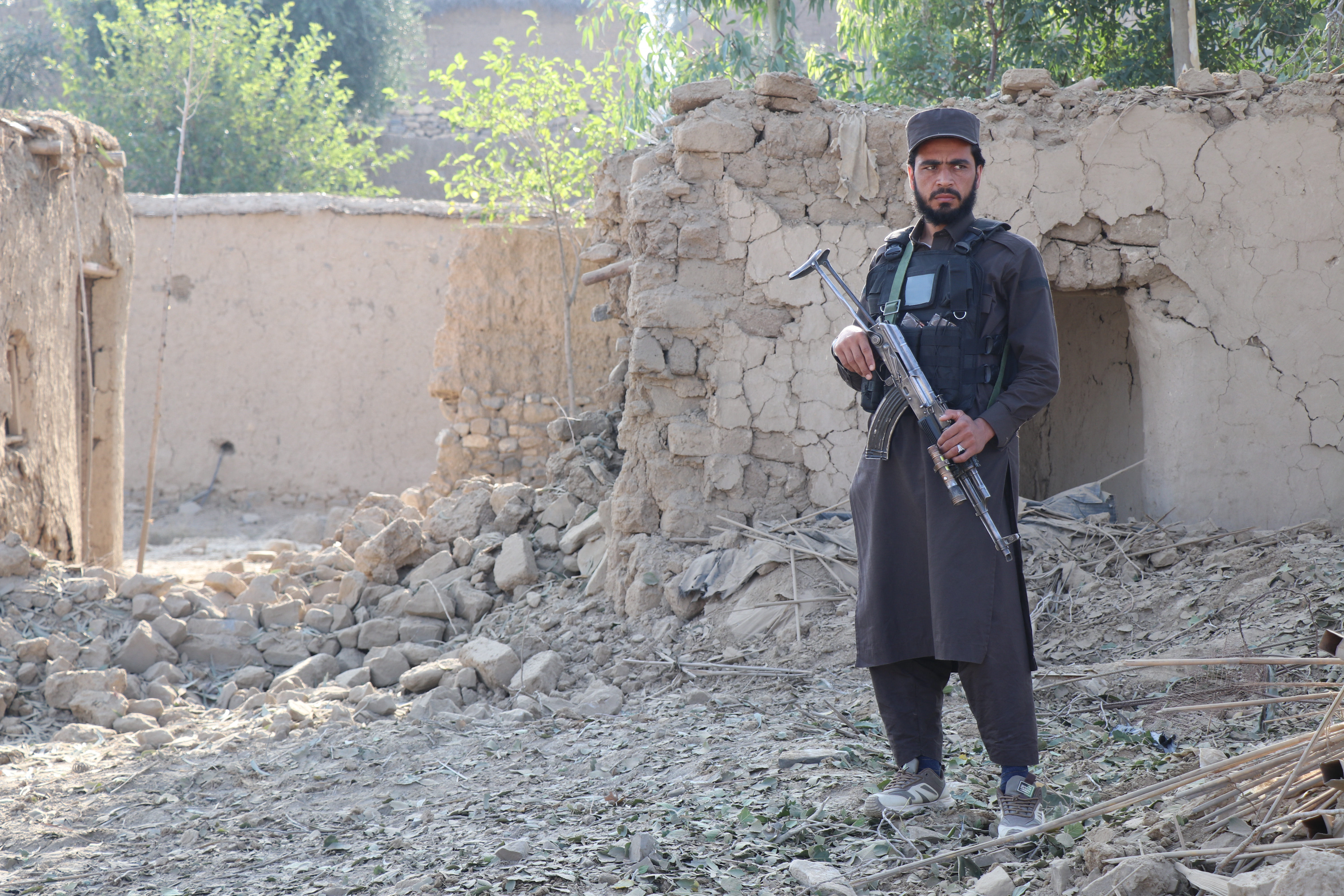 A Taliban security personnel stands guard near a damaged house, after Pakistani airstrike struck Gurbuz district in Afghanistan's Khost province on September 24, 2026.