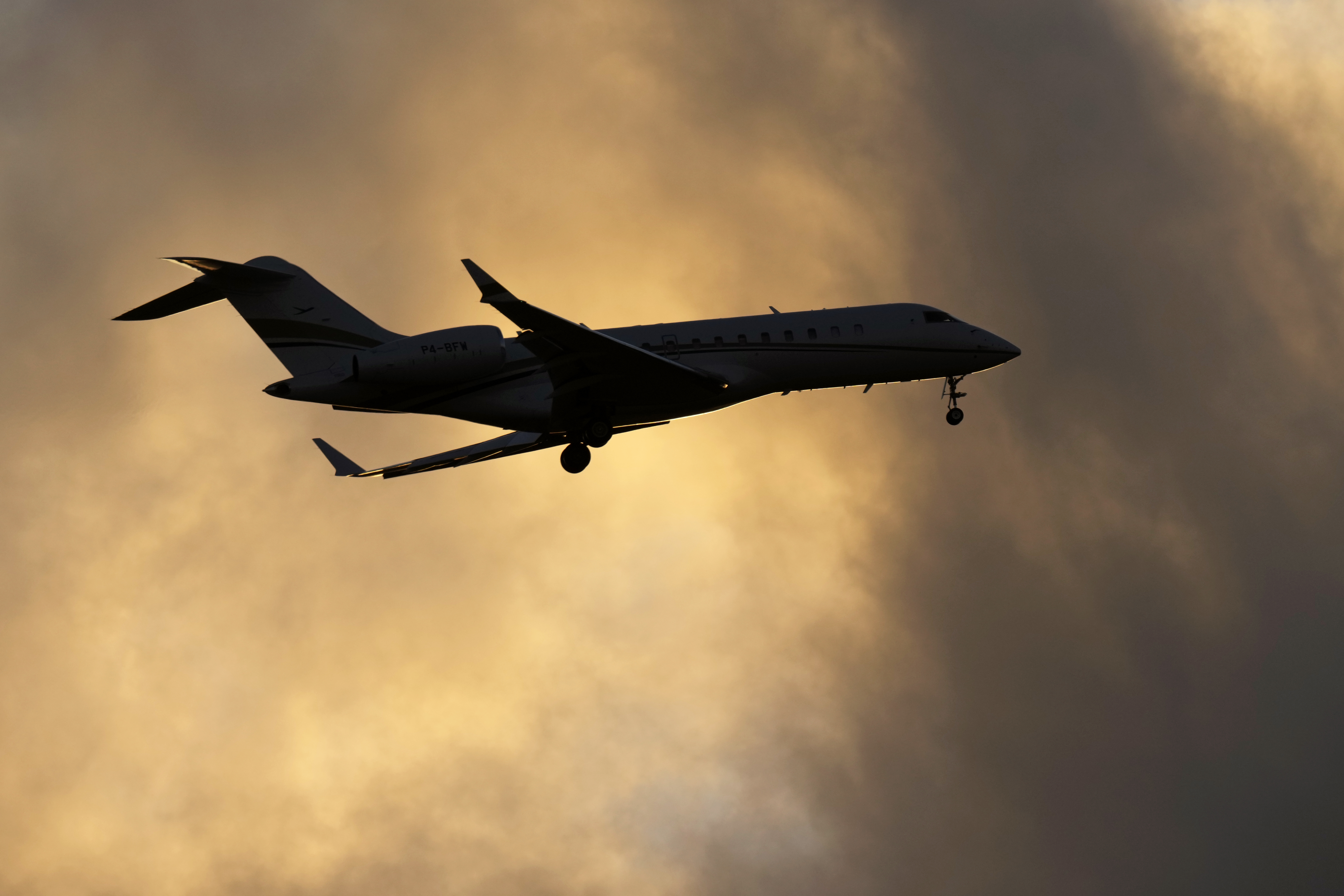 A Bombardier Global Express business jet approaches for landing in Lisbon, at sunset, Tuesday, June 13, 2023. (AP Photo/Armando Franca)