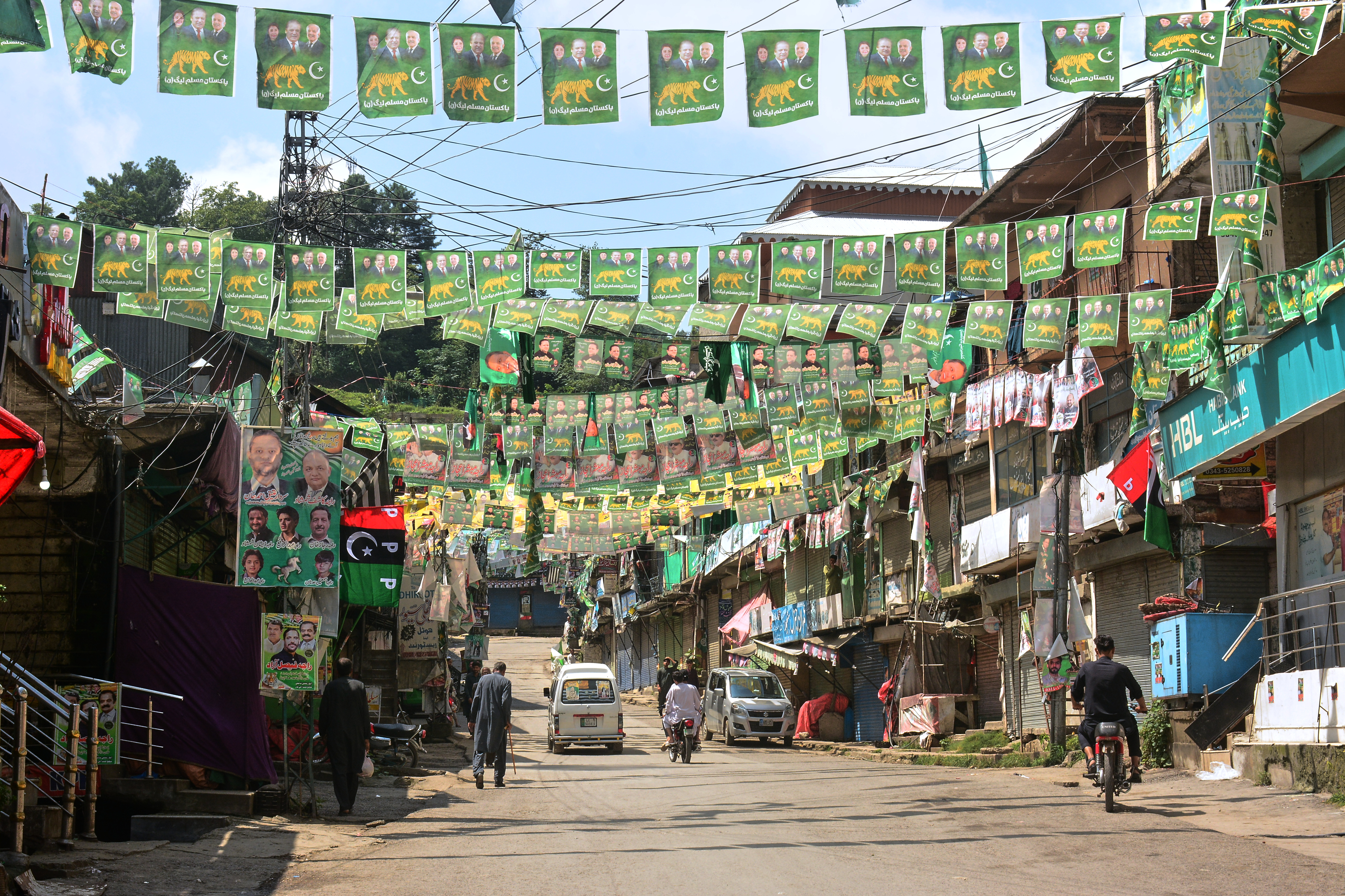 Election campaign signs at a market closed due to the final phase of elections for the legislative assembly of Pakistan-administered Kashmir