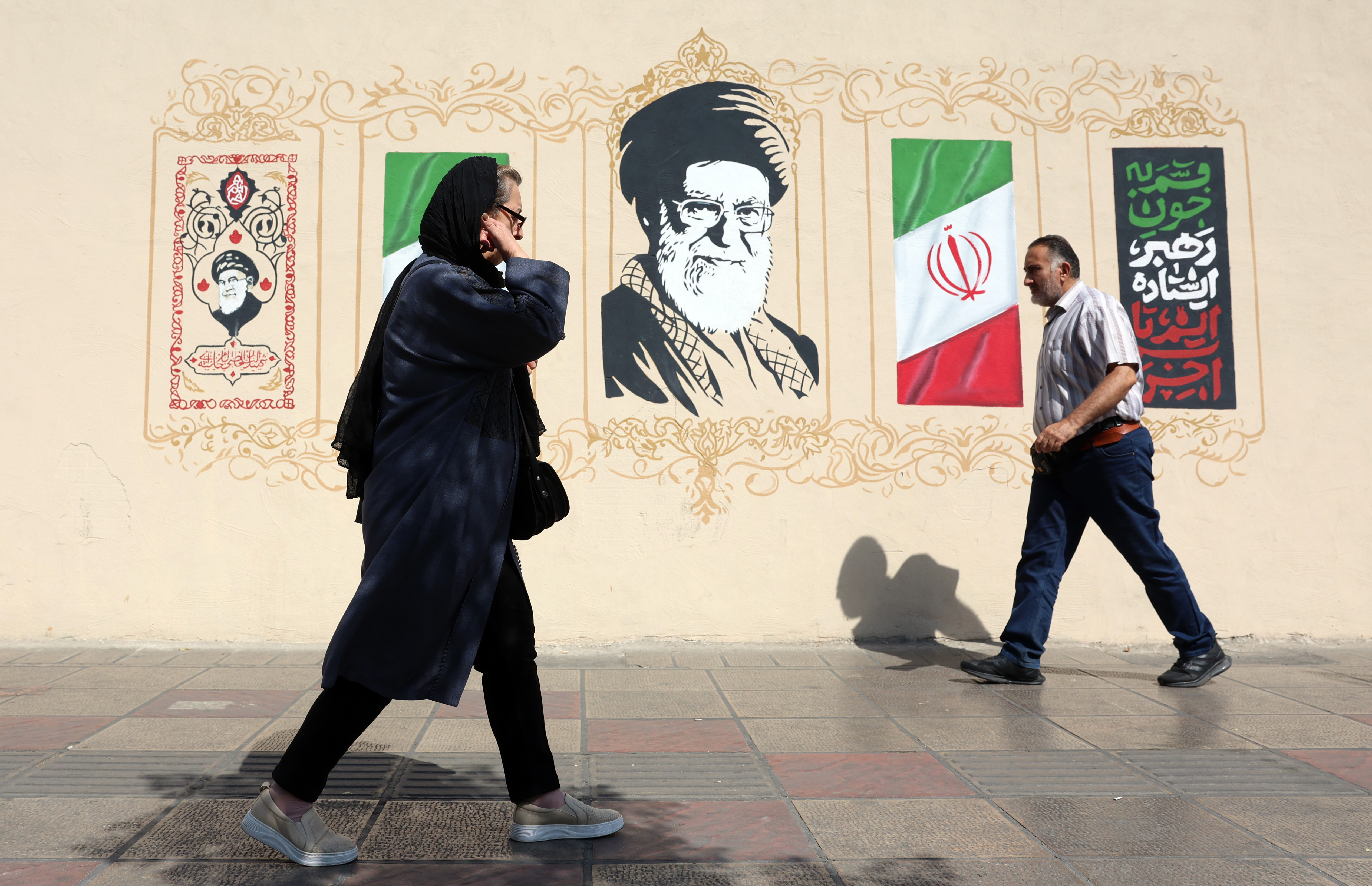 Iranians walk next to wall art of late Iranian Supreme Leader Ayatollah Ali Khamenei in central Tehran, Iran, September 13, 2026 [Abedin Taherkenareh/EPA]