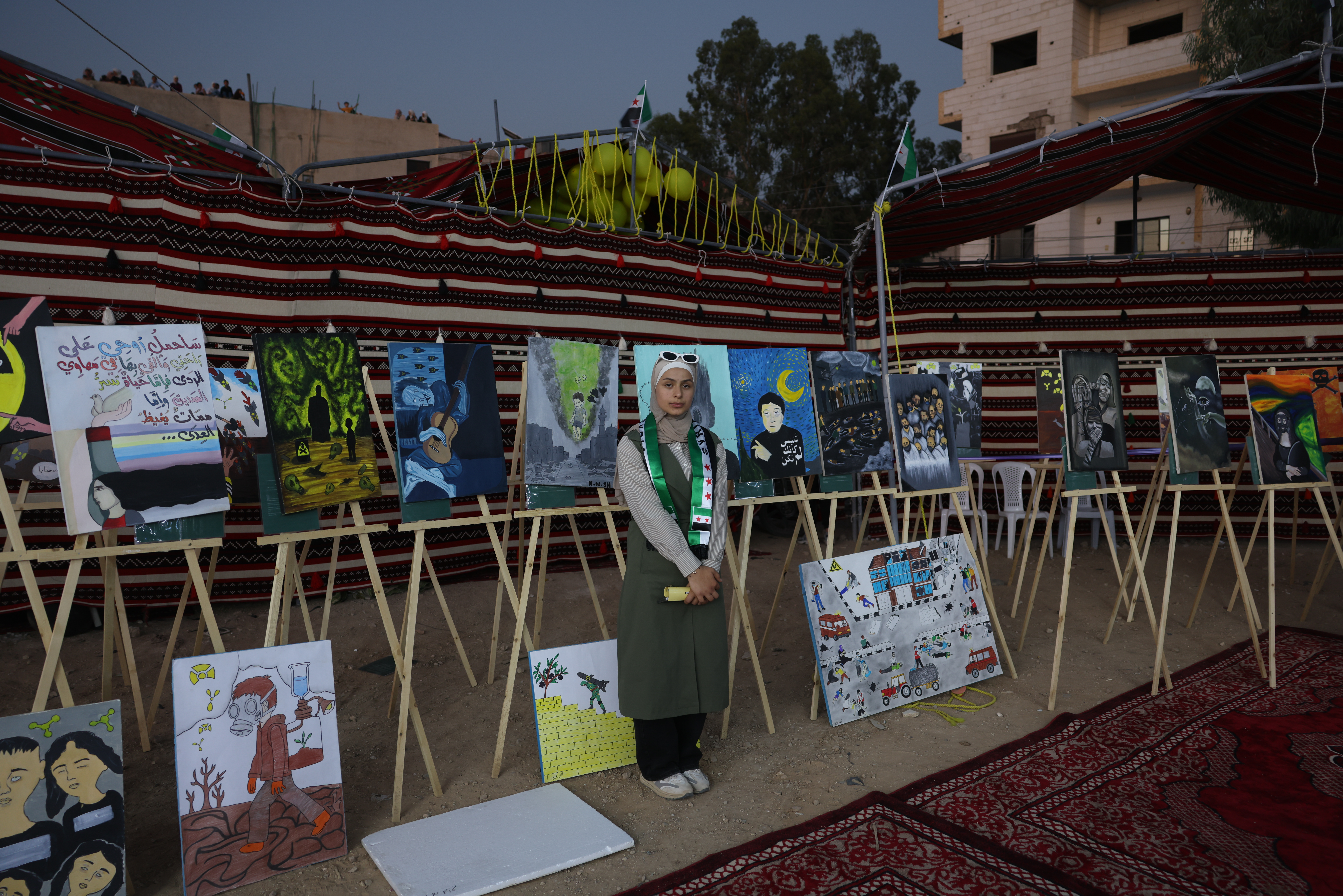 MOADAMIYAT AL-SHAM, SYRIA - AUGUST 21: A drawing exhibition by a group of young men and women depicting various scenes related to the chemical attack, during an event commemorating the attack on August 21, 2025 in Moadamiyat Al-Sham, Syria. On 21 August 2013 President Bashar al-Assad ordered strikes on two opposition-controlled areas of Ghouta, in the suburbs around Damascus. The rockets contained the chemical nerve agent Sarin which went on to kill up to 1700 people. The attack was the deadliest use of chemical weapons since the Iran-Iraq War. (Photo by Ali Haj Suleiman/Getty Images)