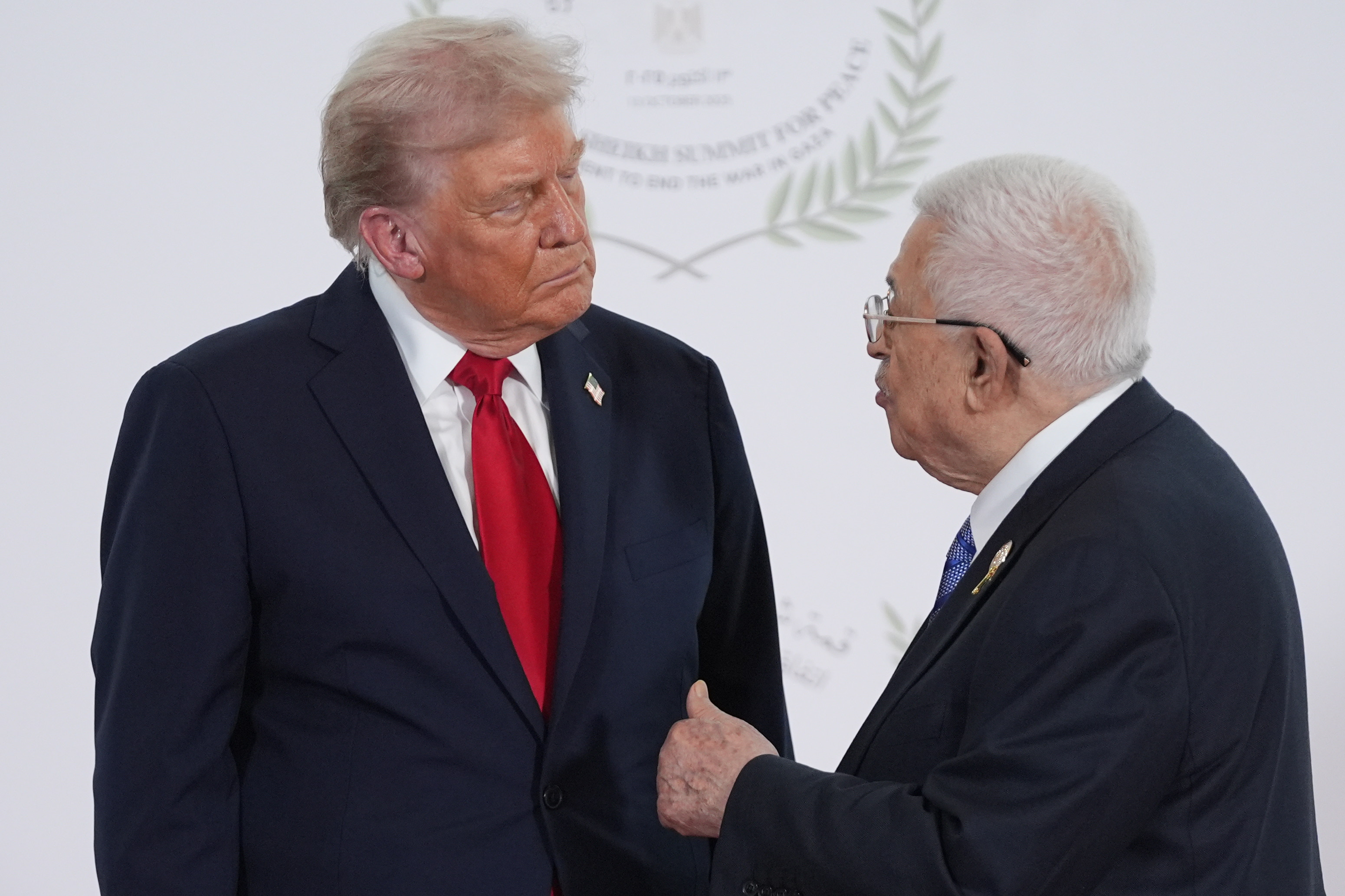 SHARM EL-SHEIKH, EGYPT - OCTOBER 13: U.S. President Donald Trump greets Palestinian President Mahmoud Abbas during a world leaders' summit on ending the Gaza war on October 13, 2025 in Sharm El-Sheikh, Egypt. President Trump is in Egypt to meet with European and Middle Eastern leaders in what’s being billed as an international peace summit, following the start of a US-brokered ceasefire deal to end the war in the Gaza Strip. (Photo by Evan Vucci - Pool / Getty Images)