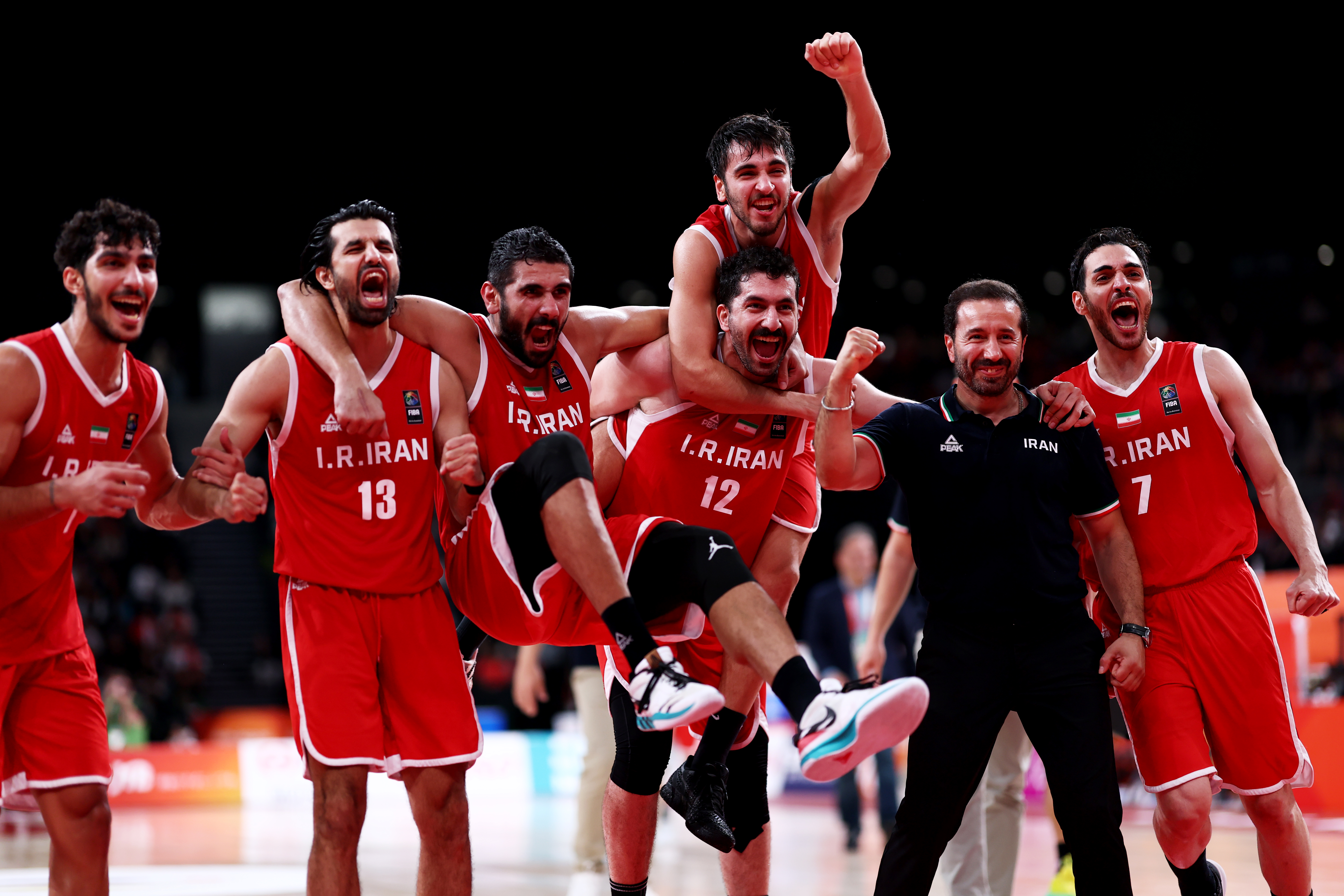Iran players celebrate after winning the Basketball men's bronze medal game against China at the 20th Asian Games