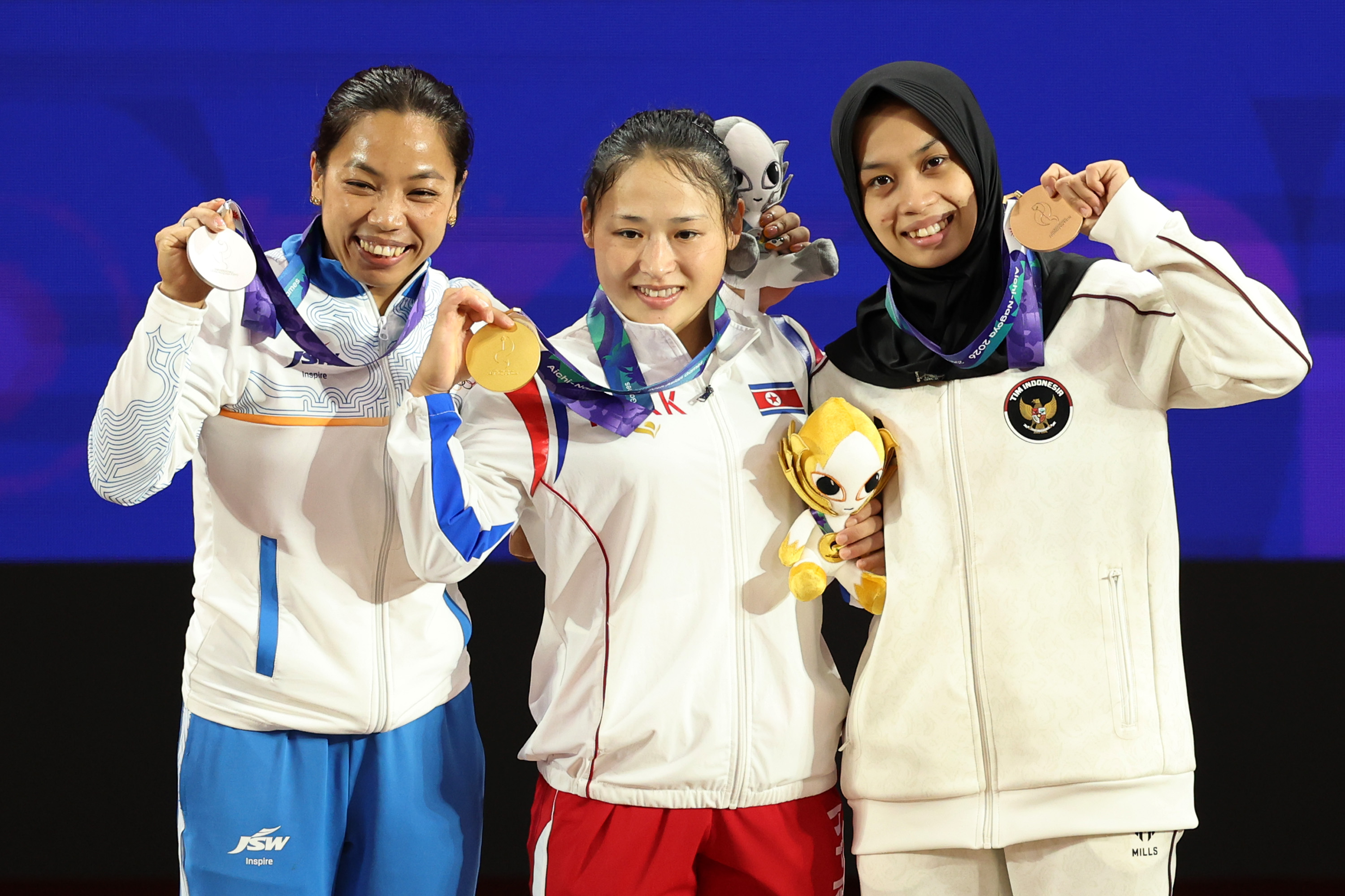 India’s Mirabai Chanu, North Korea's Ri Song Gum and Luluk Diana Tri Wijayana of Indonesia