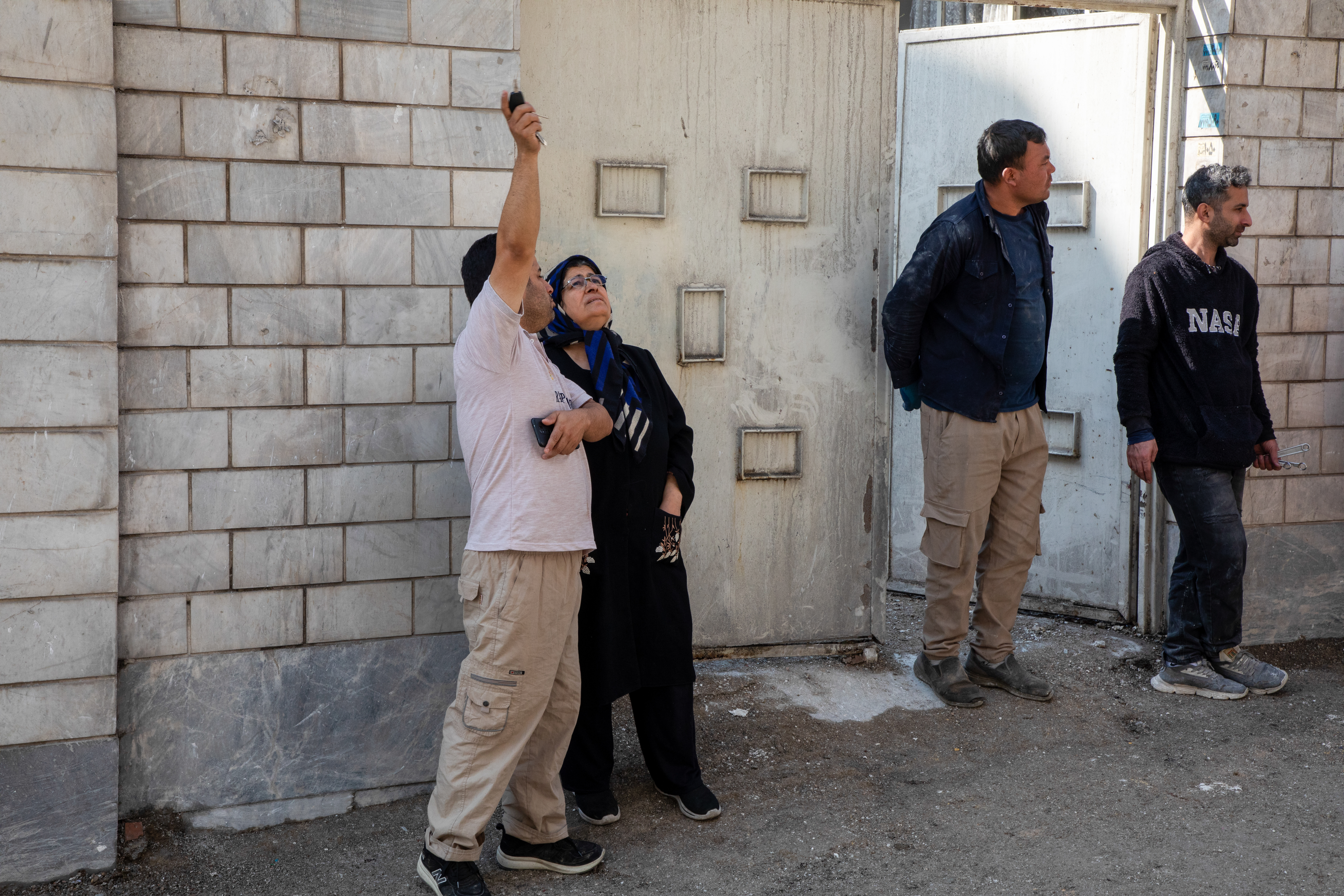 TEHRAN, IRAN - MARCH 31: People survey damage in the aftermath of a drone attack on a residential building in which one civilian was killed on March 31, 2026 in eastern Tehran, Iran. The United States and Israel continued their joint attack on Iran that began on February 28. Iran retaliated by firing waves of missiles and drones at Israel, and targeting U.S. allies in the region. (Photo by Majid Saeedi/Getty Images)