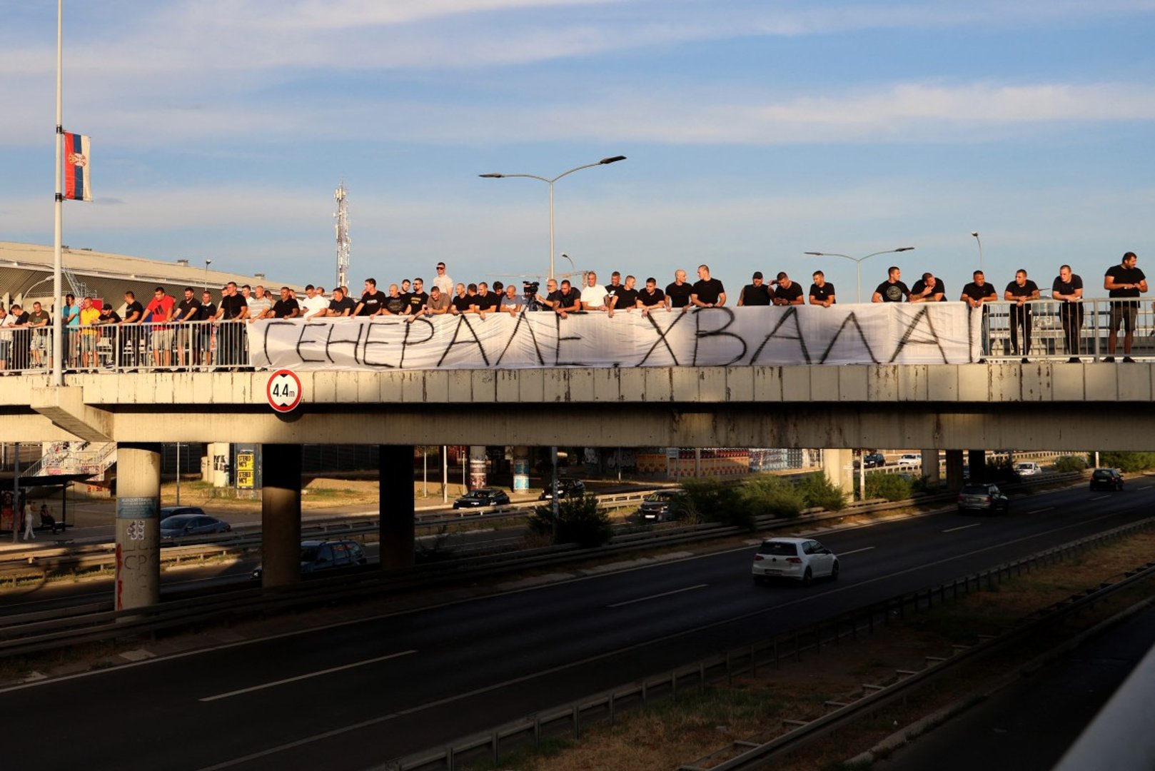 People gathered on a footbridge over a motorway light flares and hold a banner reading &ldquo;Thank you general&rdquo; as a convoy carrying the body of convicted Bosnian Serb war criminal Ratko Mladic passes through Belgrade [AFP]