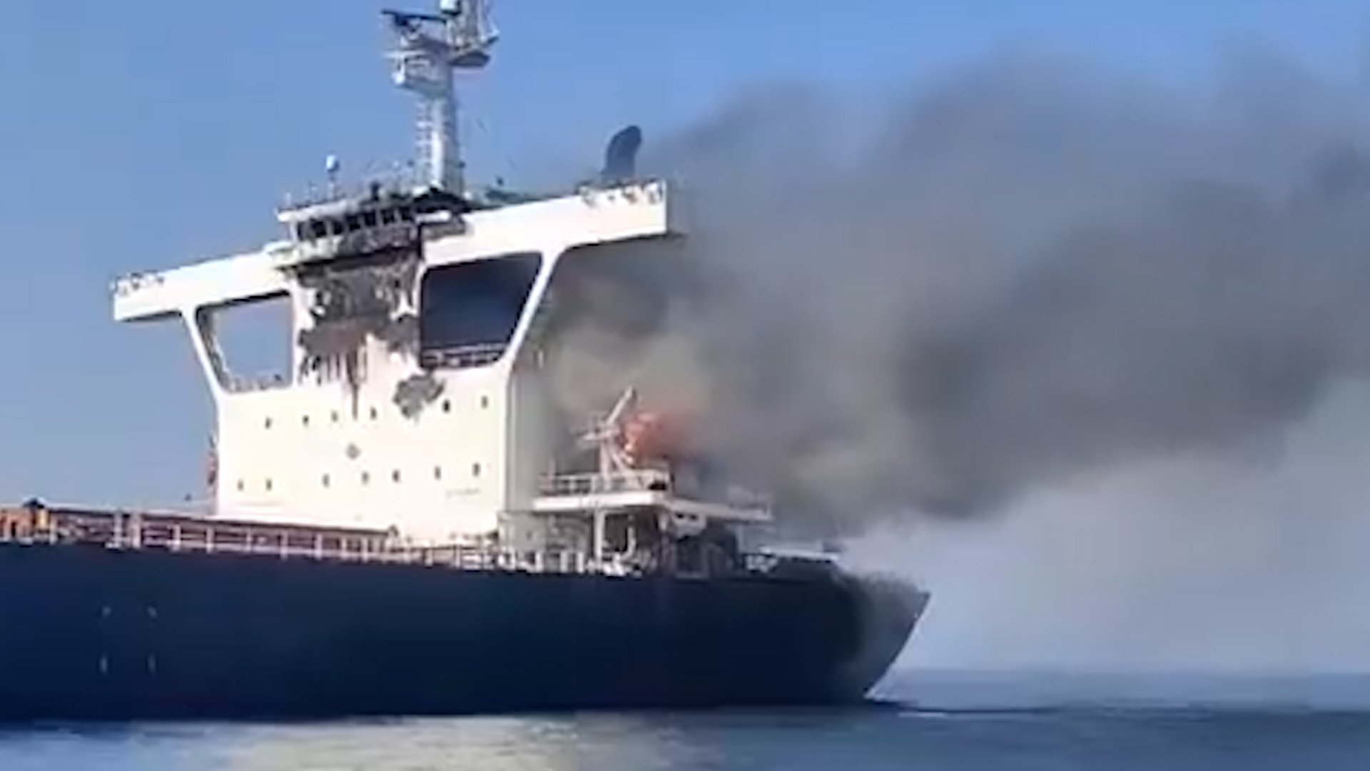 Smoke coming out of a damaged cargo vessel off the coast of Oman