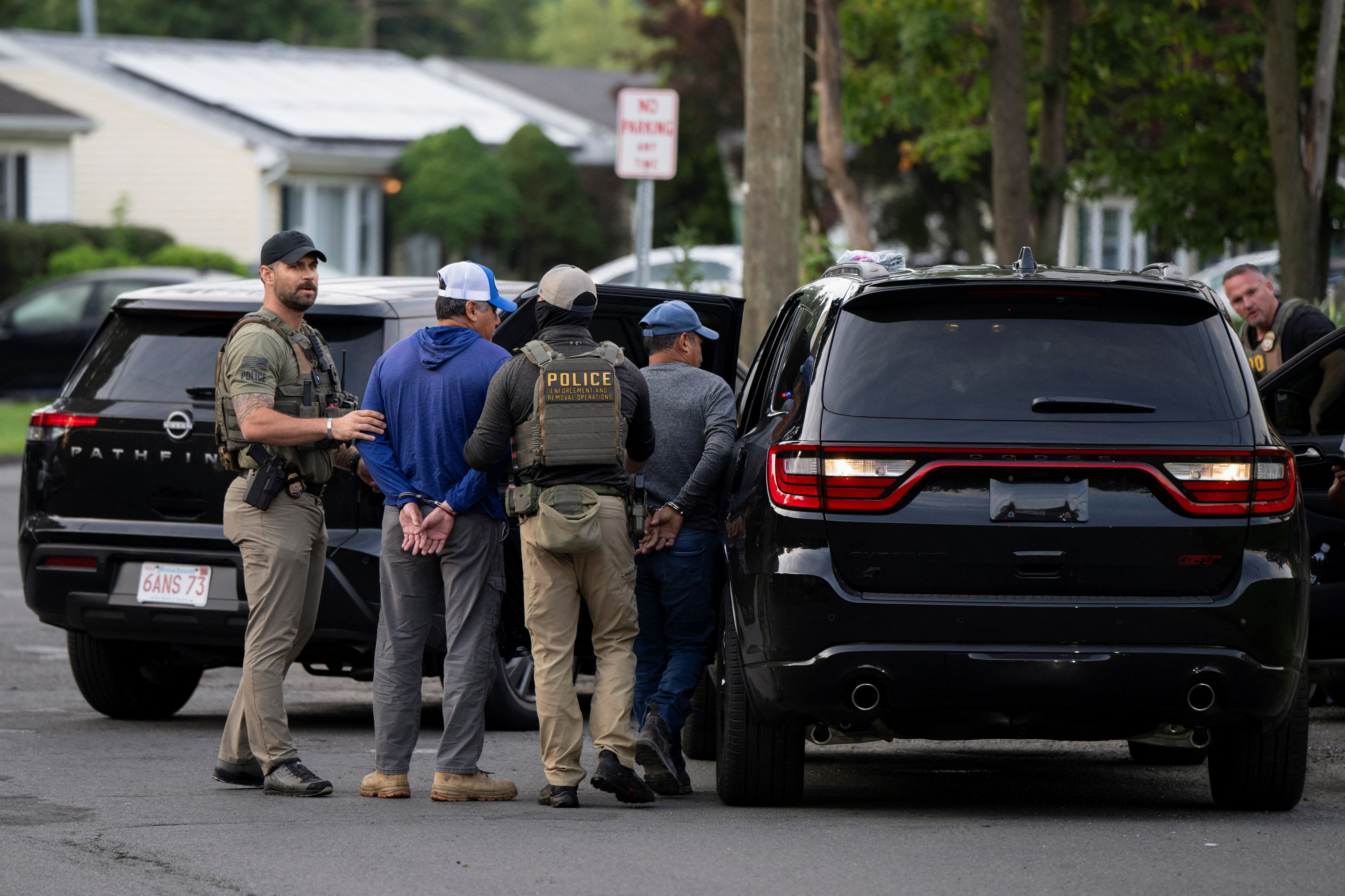 Immigration and Customs Enforcement (ICE) agents detain two individuals outside a home in Danbury, Connecticut, U.S., August 27, 2026. REUTERS/Vincent Alban