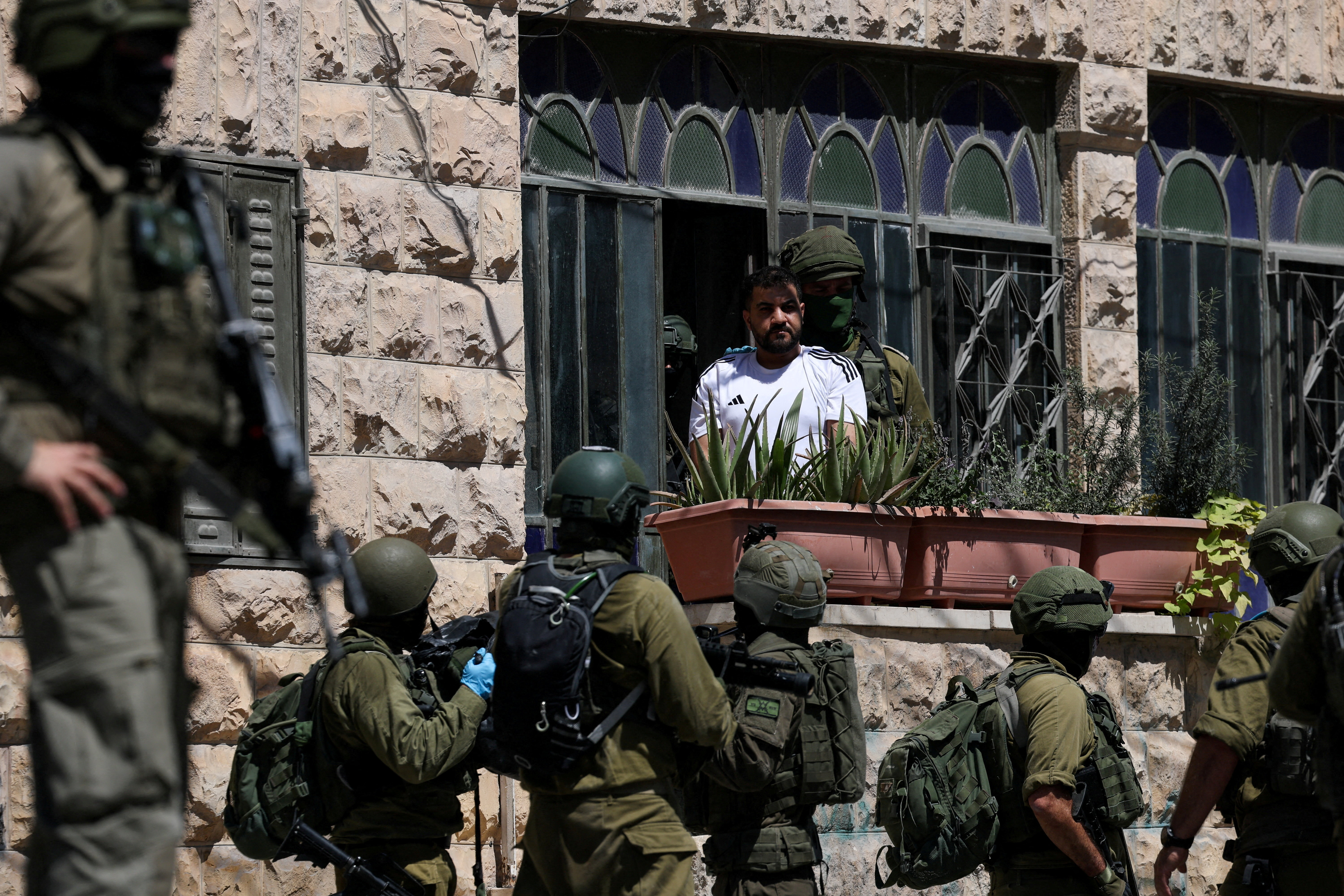 Israeli soldiers detain a Palestinian man, as they conduct raid in Anata, in the Israeli-occupied West Bank, September 8, 2026. REUTERS/Ammar Awad REFILE - CORRECTING ACTION FROM "ISRAELI SOLDIERS TALK TO A PALESTINIAN MAN" TO "ISRAELI SOLDIERS DETAIN A PALESTINIAN MAN". TPX IMAGES OF THE DAY