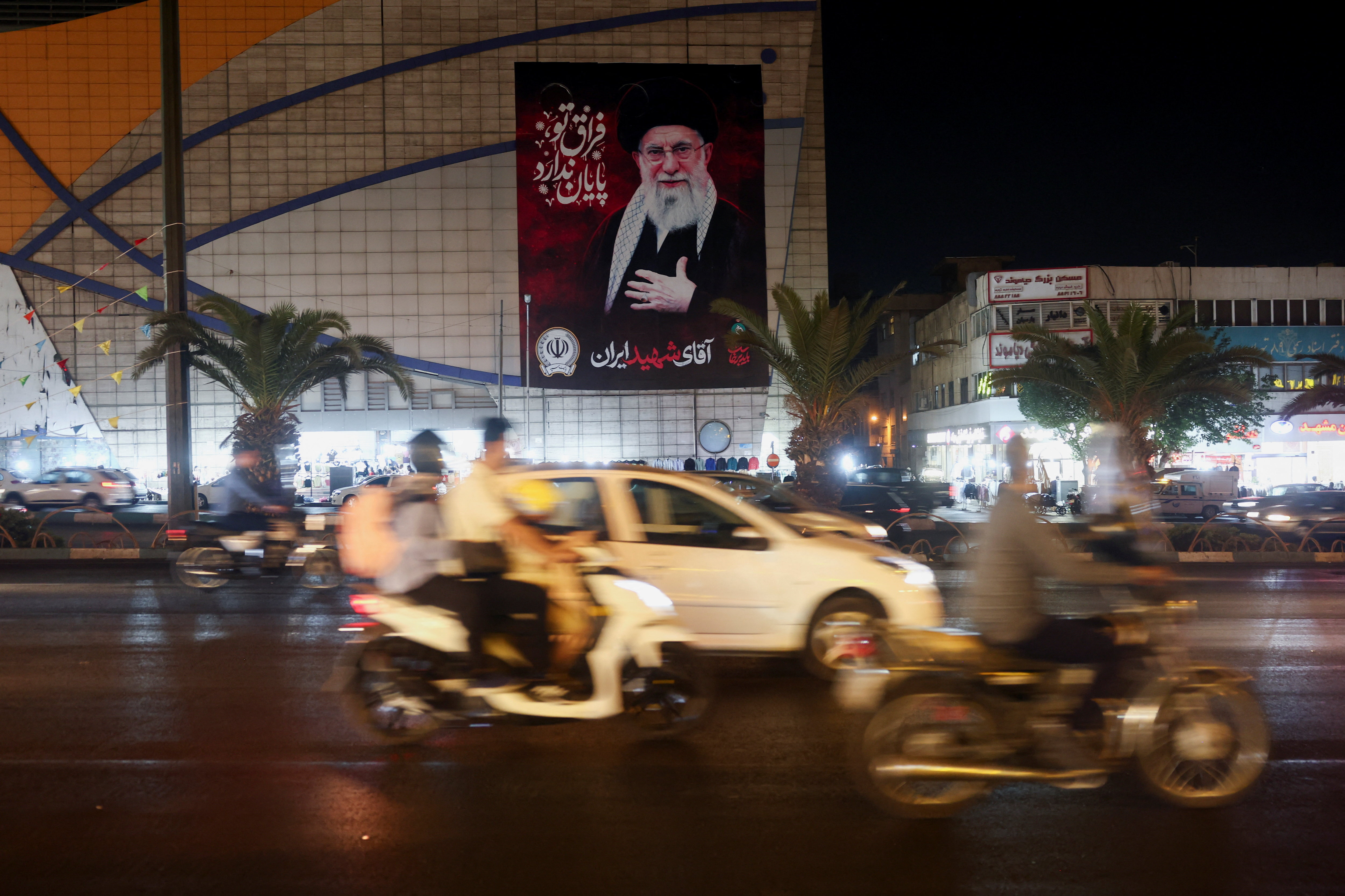 People drive past a billboard depicting Iran's late Supreme Leader Ayatollah Ali Khamenei, on a street in Tehran, Iran, August 23, 2026. Majid Asgaripour/WANA (West Asia News Agency) via REUTERS ATTENTION EDITORS - THIS PICTURE WAS PROVIDED BY A THIRD PARTY. ISRAEL OUT. NO COMMERCIAL OR EDITORIAL SALES IN ISRAEL. NO ACCESS FOR ISRAELI MEDIA. NO USE BBC PERSIAN. NO USE VOA PERSIAN. NO USE MANOTO. NO USE IRAN INTERNATIONAL. NO USE RADIO FARDA. DIGITAL: NO USE BBC PERSIAN. NO USE VOA PERSIAN. NO USE MANOTO. NO USE IRAN INTERNATIONAL. NO USE RADIO FARDA.