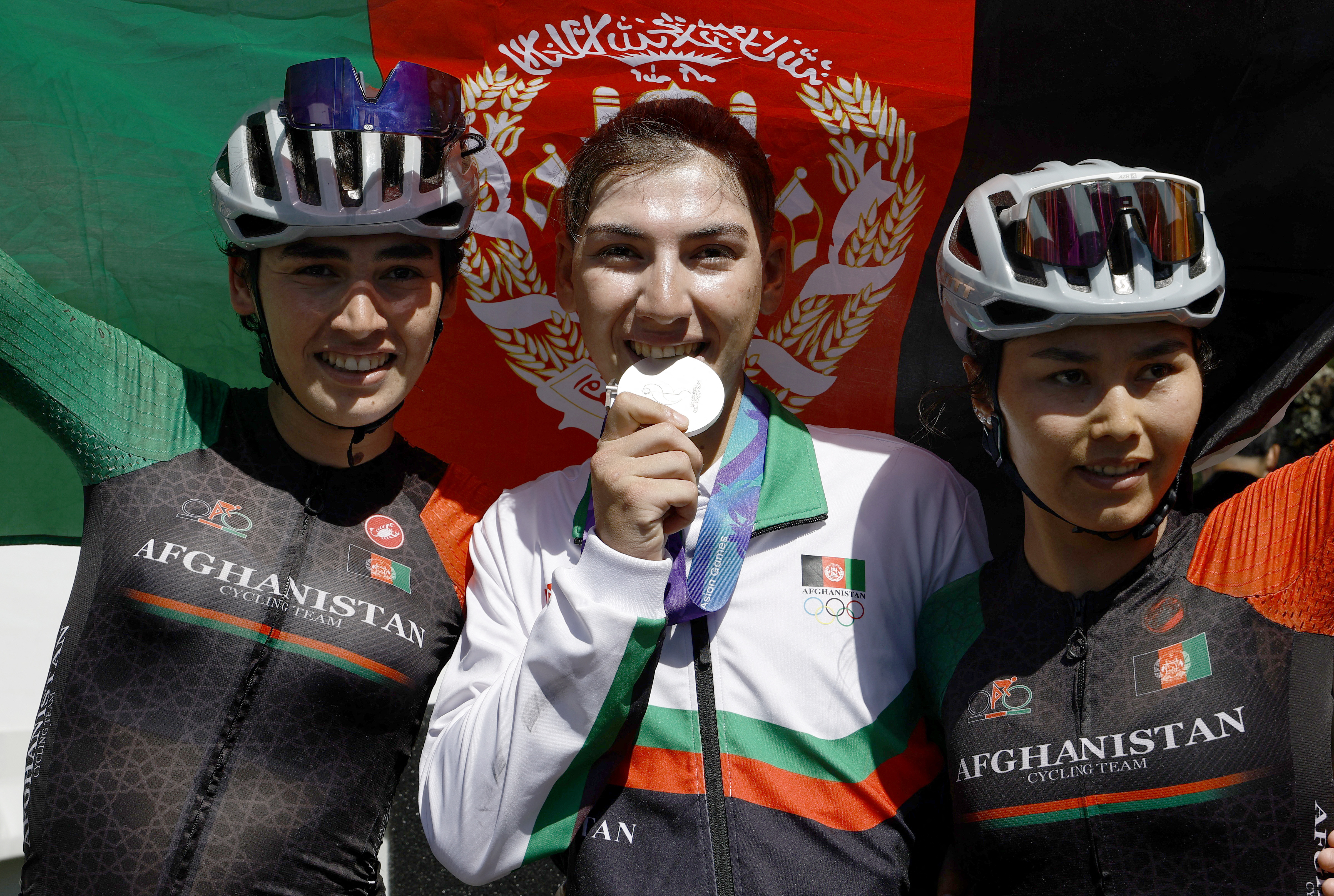Hashimi and her teammates Yuldoz Hashimi and Zahra Rezayee during the medal ceremony in Japan